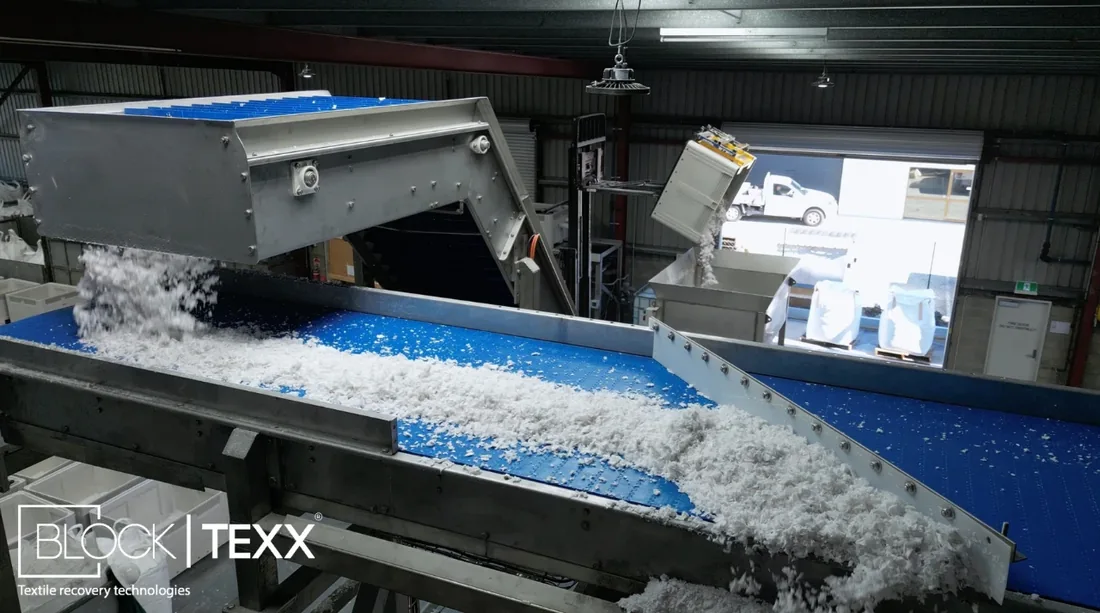 Textile material moving along a conveyor inside the BlockTexx facility
